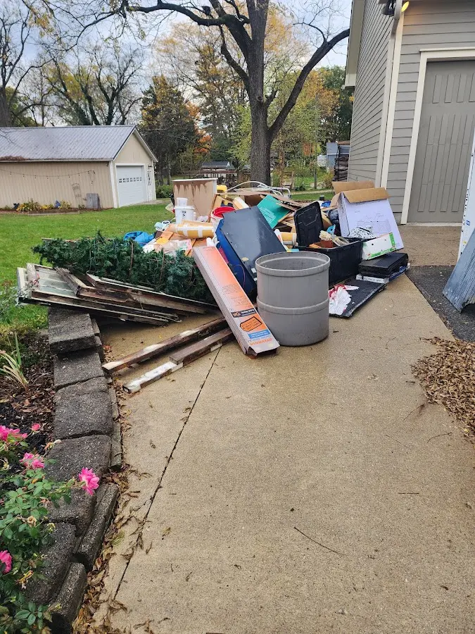 Dumpster being loaded with debris for Estate Cleanout Dumpster Rental in Forsyth